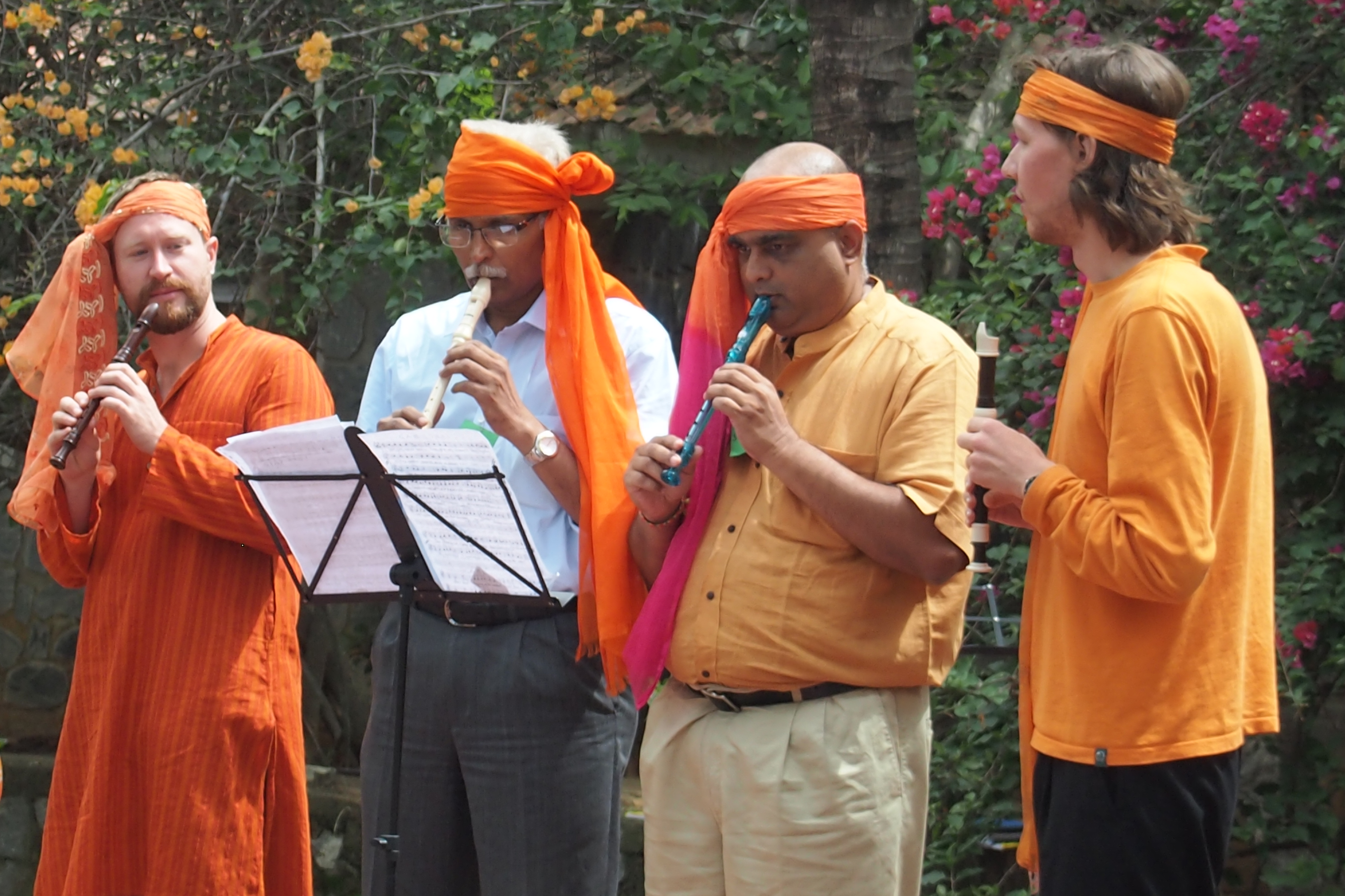 Wayfarers and local musicians playing traditional flutes together