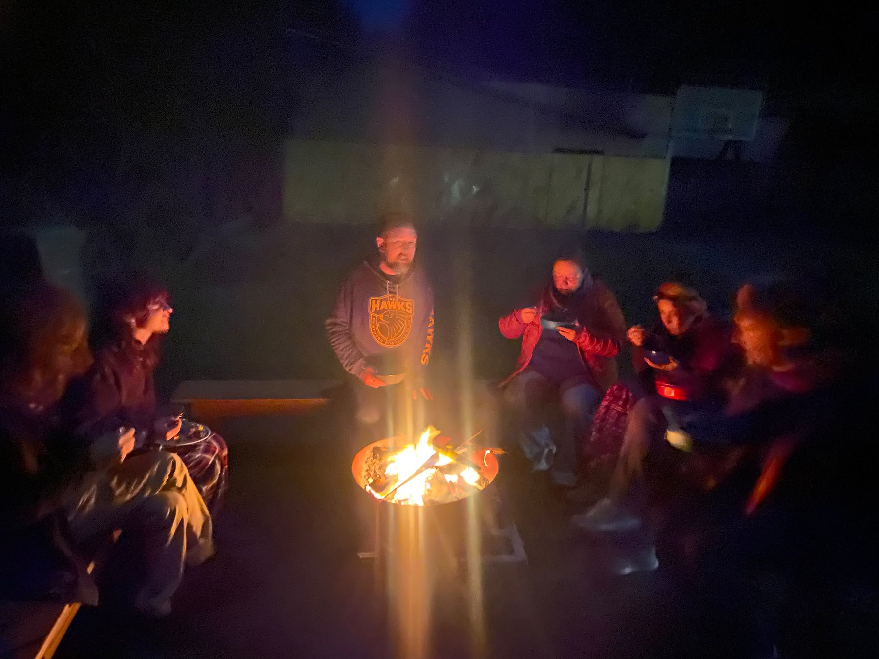 Wayfarers relaxing together around a campfire